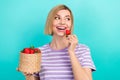 Portrait of adorable satisfied woman stylish t-shirt hold basket with strawberry look empty space isolated on teal color