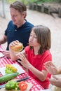 Portrait of adorable schoolboy eating hamburger