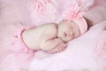 Portrait of adorable sleeping baby girl over pink, infant child. Royalty Free Stock Photo