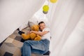 Portrait of adorable small schoolboy lying floor cuddle plushie tent fort toys wear white shirt modern interior playroom Royalty Free Stock Photo