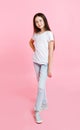 Portrait of adorable smiling little girl child in jeans and white t-shirt isolated Royalty Free Stock Photo