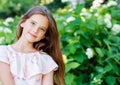 Portrait of adorable smiling little girl child in summer day. Happy preteen in the park Royalty Free Stock Photo