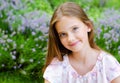 Portrait of adorable smiling little girl child in summer day. Happy preteen in the park