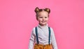 Portrait of adorable smiling little girl isolated on a pink Royalty Free Stock Photo
