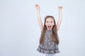 Portrait of adorable smiling little girl isolated on a white. Toddler with her hands up. Happy child. Cheerful and positive emotio Royalty Free Stock Photo