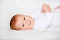 Portrait of adorableness. Little cute baby girl in white romper in bedroom Royalty Free Stock Photo