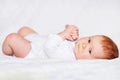 Portrait of adorableness. Little cute baby girl in white romper in bedroom Royalty Free Stock Photo