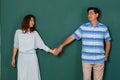 Portrait of adult Asian senior older man and woman, happy loving couple dressed casually holding hands and looking to the eyes of Royalty Free Stock Photo