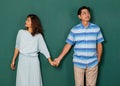 Portrait of adult Asian senior older man and woman, happy loving couple dressed casually holding hands and looking to the eyes of Royalty Free Stock Photo
