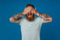 Portrait of adult bearded tattooed man with opened mouth