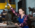 Portrait of adult female working with lift hook