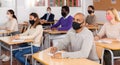 Adult hispanic man in protective mask during lesson