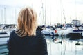 Portrait of an adult lady standing in a marina on yachts background. Royalty Free Stock Photo