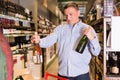 Portrait of adult man buying wine Royalty Free Stock Photo