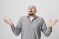 Portrait of an adult man looking up in the sky with surprised or shocked expression over white background. Person