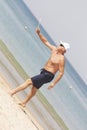 Adult male playing matkot on the beach