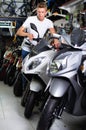 Portrait of adult man purchaser choosing motorbike