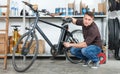 Portrait of adult master repairing bicycle