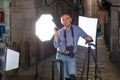 Portrait of adult photographer with his camera during photo shooting on town street Royalty Free Stock Photo