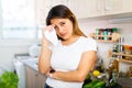 Adult sad latino woman tired of worries at kitchen Royalty Free Stock Photo