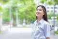 Portrait of adult Thai student in university student uniform. Asian beautiful girl standing smiling confidence at outdoors