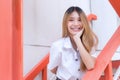 Portrait of an adult Thai student in university student uniform. Asian beautiful girl standing smiling happily and where her teeth Royalty Free Stock Photo