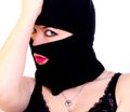 Portrait of an adult woman in a criminal mask on a white background