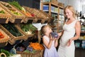 Portrait of adult woman and girl gladly shopping Royalty Free Stock Photo