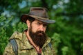 Portrait of adventure serious man extreme explorer. Man hunter in camouflage outdoor. Brutal hunter, bearded man in the Royalty Free Stock Photo