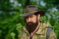 Portrait of adventure serious man extreme explorer. Man hunter in camouflage outdoor. Brutal hunter, bearded man in the Royalty Free Stock Photo