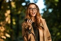 Portrait of affable woman using cell phone while walking through empty boulevard Royalty Free Stock Photo