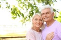 Portrait of affectionate senior couple on city street