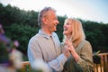 Portrait of affectionate senior couple spending time together and dancing in garden at home. Royalty Free Stock Photo