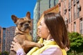 Portrait caring young pet owner showing tenderness small dog outdoors