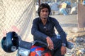 Portrait of an Afghan motorcyclist resting in shade, southern Ir