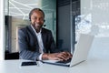 Portrait of african american businessman inside office at workplace, mature man using headset phone and laptop for Royalty Free Stock Photo