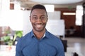 Portrait of african american businessman standing in office smiling to camera Royalty Free Stock Photo