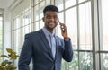 African american businessman using smartphone to talk business in the office Royalty Free Stock Photo