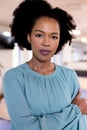 Portrait of african american businesswoman with arms crossed in modern office Royalty Free Stock Photo