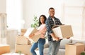 Portrait of African American couple with cardboard boxes moving to their new home together, blank space Royalty Free Stock Photo