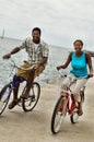 Portrait of african american couple riding bicycle on seashore