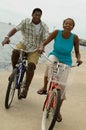 Portrait of african american couple riding bicycle on seashore