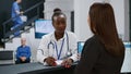 Portrait of african american doctor working on chekcup reports