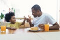 Portrait of African American family having breakfast having a meal together and showing thumbs up gesture at home.Family enjoy Royalty Free Stock Photo