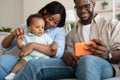 Portrait of african american family using cell phone at home Royalty Free Stock Photo