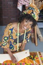 Portrait of an African American female fashion designer working on fabric Royalty Free Stock Photo