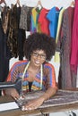 Portrait of an African American female tailor stitching cloth on sewing machine Royalty Free Stock Photo