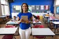 Portrait of african american female teacher holding digital tablet smiling in the class at school Royalty Free Stock Photo