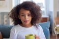 Portrait of African American girl with yellow mug Royalty Free Stock Photo