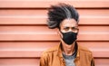 Portrait of african american guy wearing black protective face mask - New normal lifestyle concept with young man Royalty Free Stock Photo